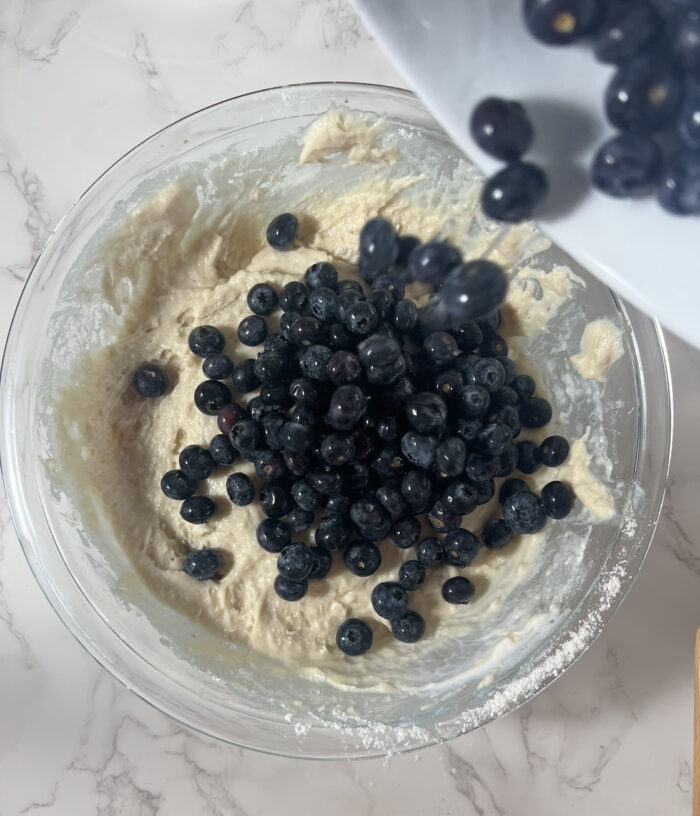 Addition of blueberries to the batter. 