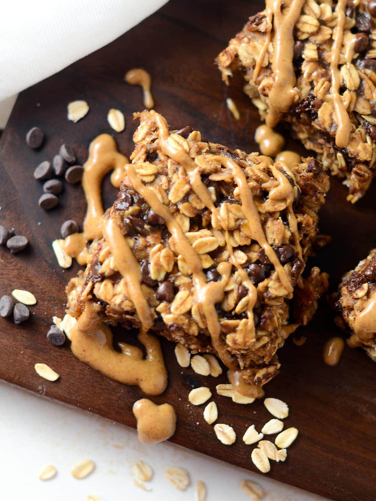 This is a photo of a peanut butter banana oatmeal bar with a peanut butter drizzle.