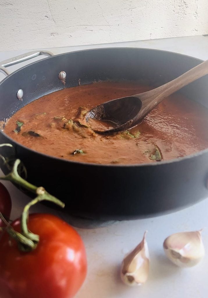 This is a photo of a pan with tomato sauce in it. 