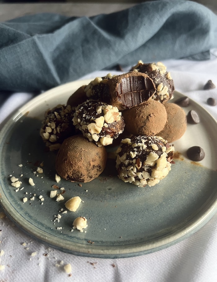 This is a picture of vegan chocolates truffles on a plate.