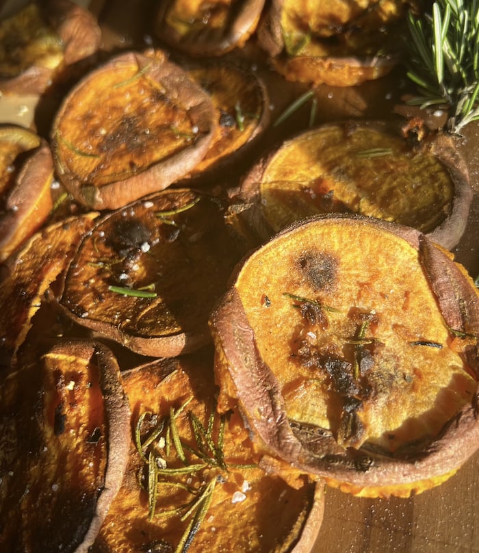 This is a picture of crispy rosemary garlic butter smashed sweet potatoes. 