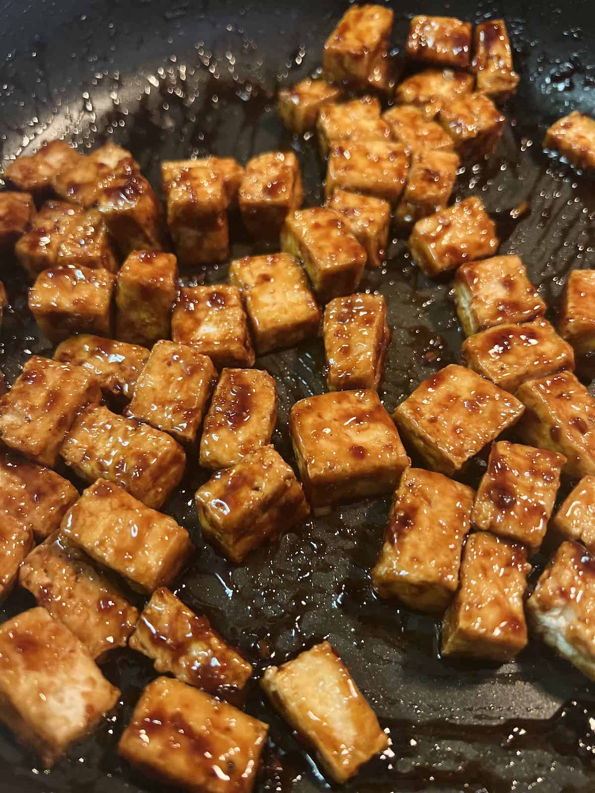 This is a photo of sticky tofu in sauce on the stove.