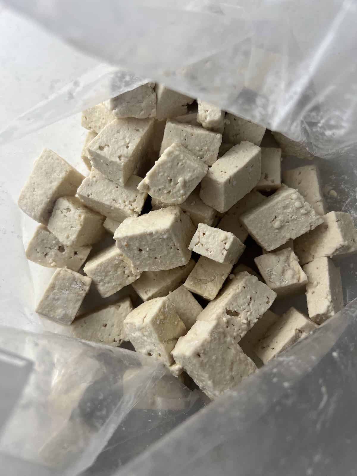 This is a photo of tofu with cornstarch in a bag. 