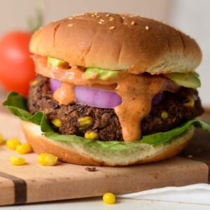 This is a photo of a black bean burger with burger sauce.