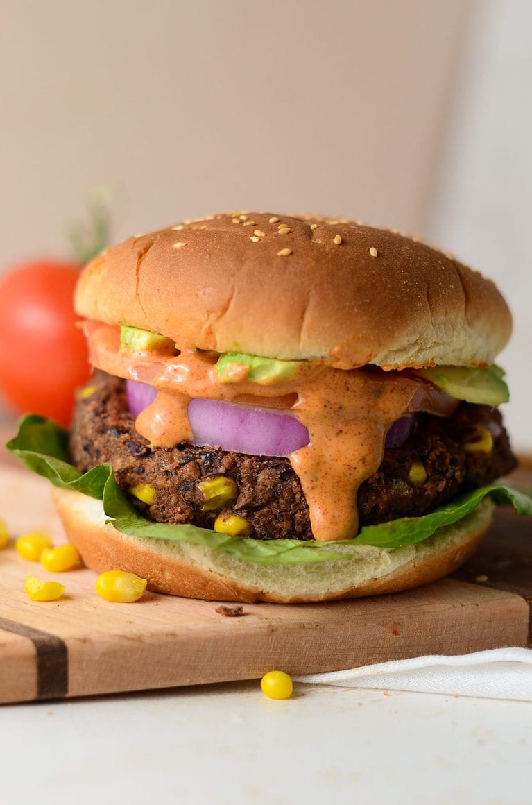 This is a photo of a black bean burger with burger sauce.