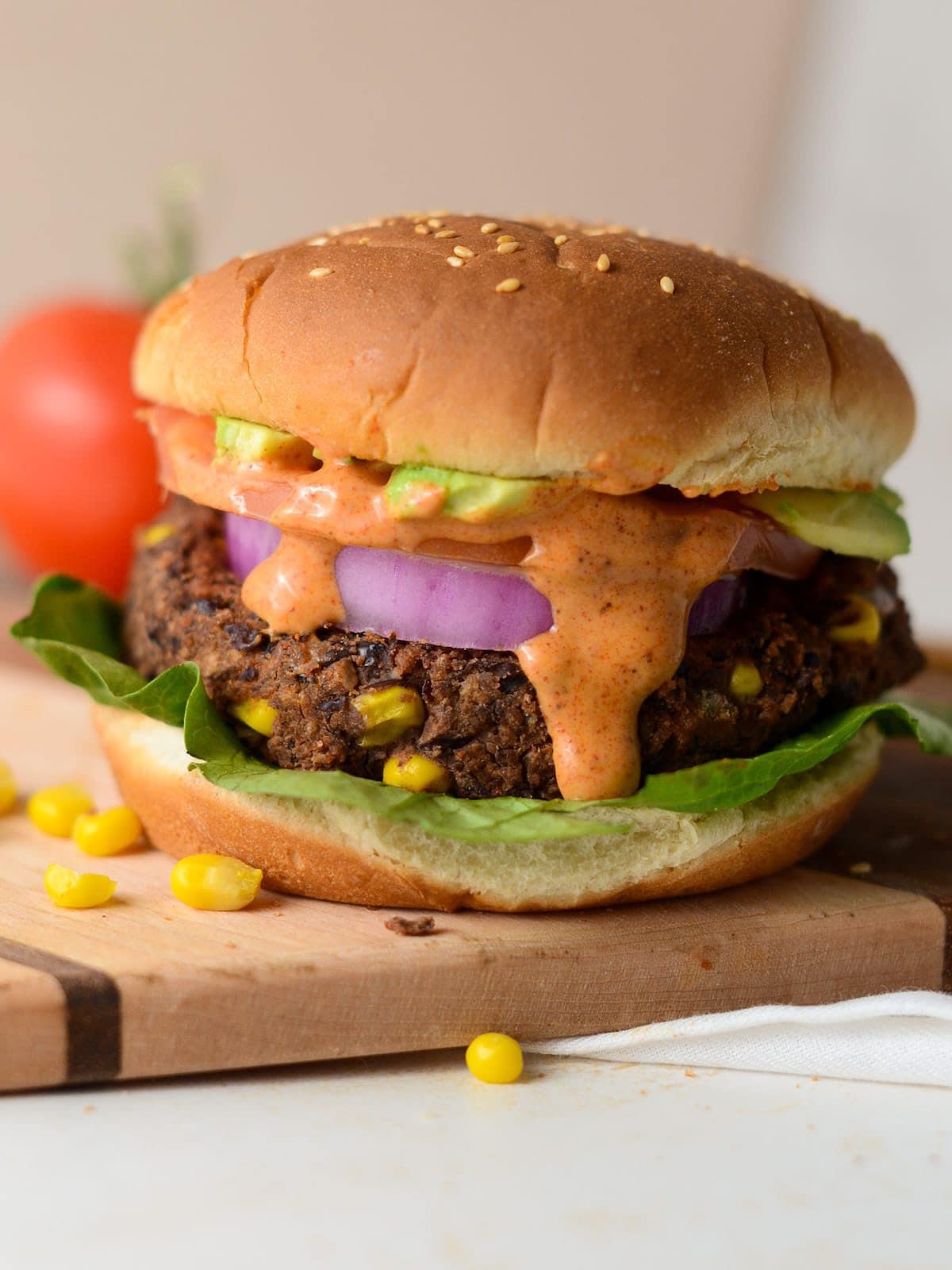 This is a photo of a southwest black bean burger with the burger sauce drizzle.