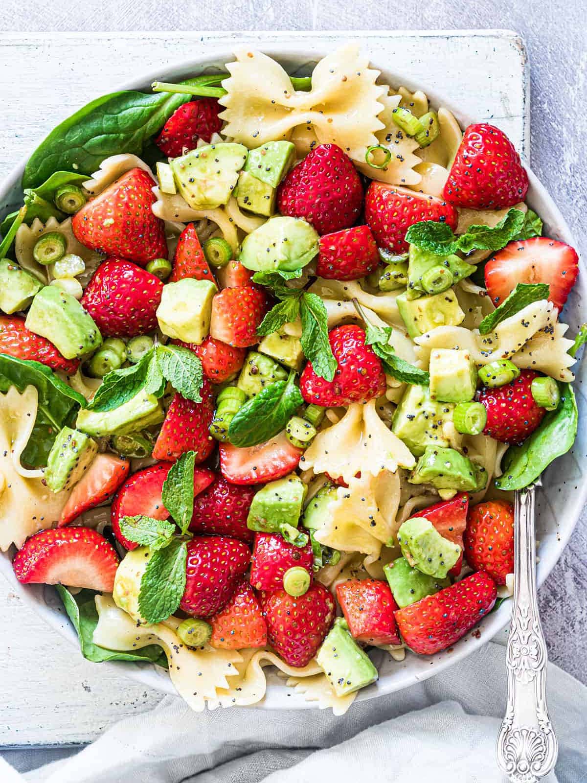 photo of strawberry avocado pasta salad overhead shot