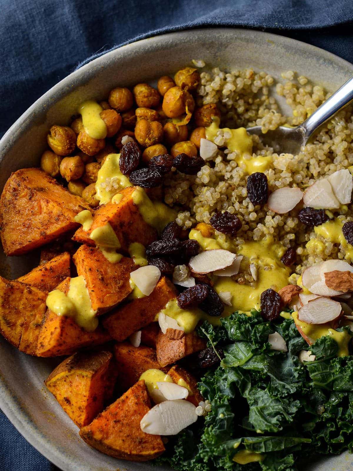This is a photo of an overhead shot of the moroccan sweet potato nourish bowl with the sauce drizzled on top. 