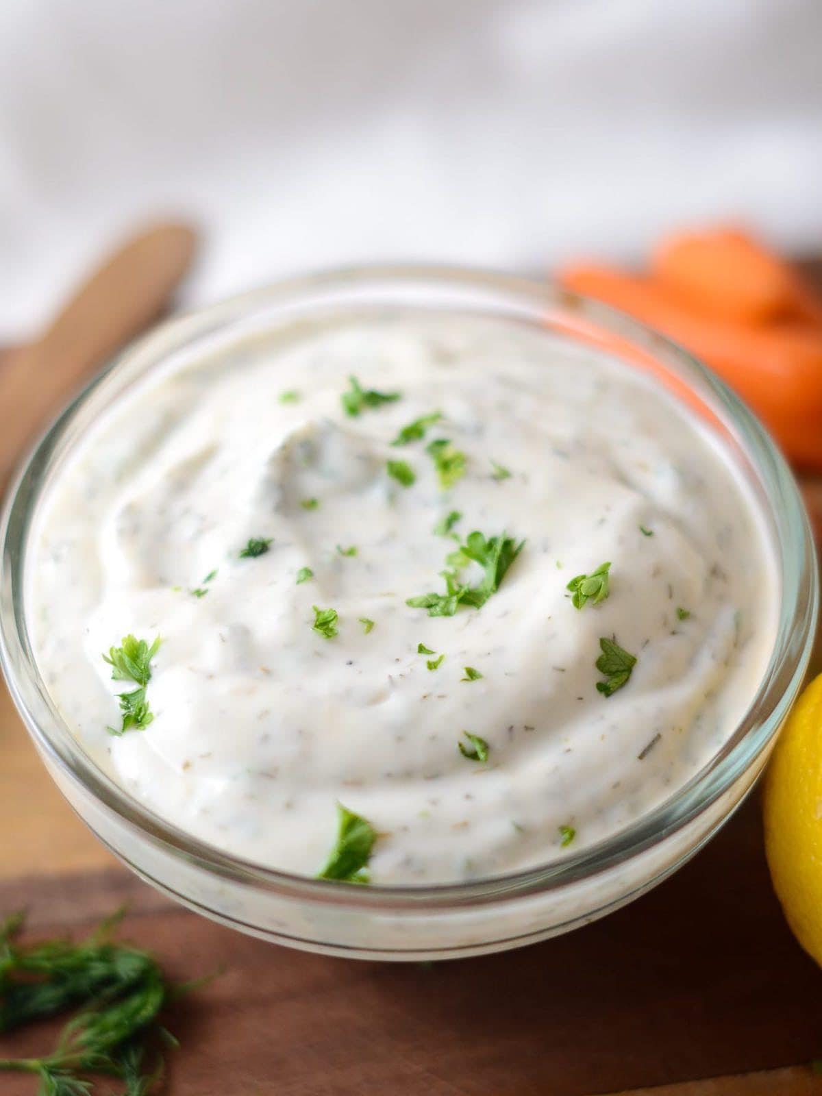 This is a photo of ranch dip close up with parsley on top