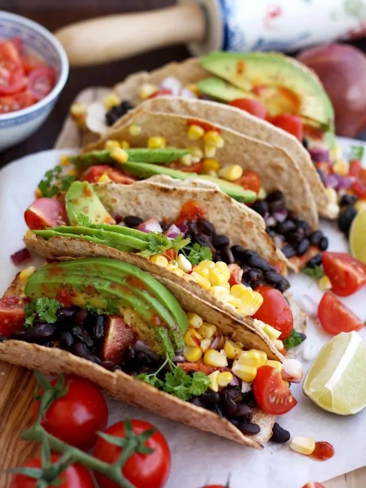 a stack of vegan tacos with avocado. 