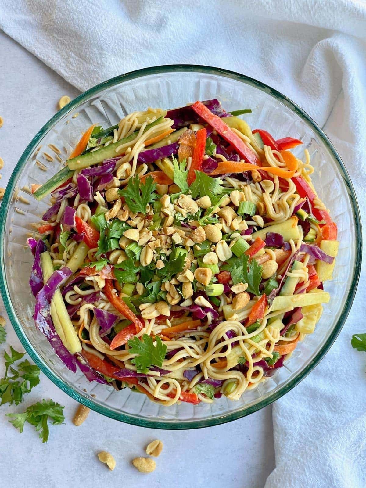 a large bowl of thai noodle salad with peanuts. 