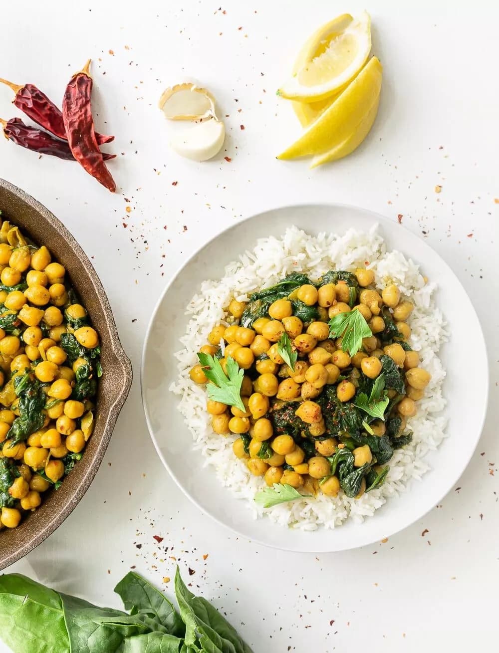 chickpea curry over rice, lemons on the side. 