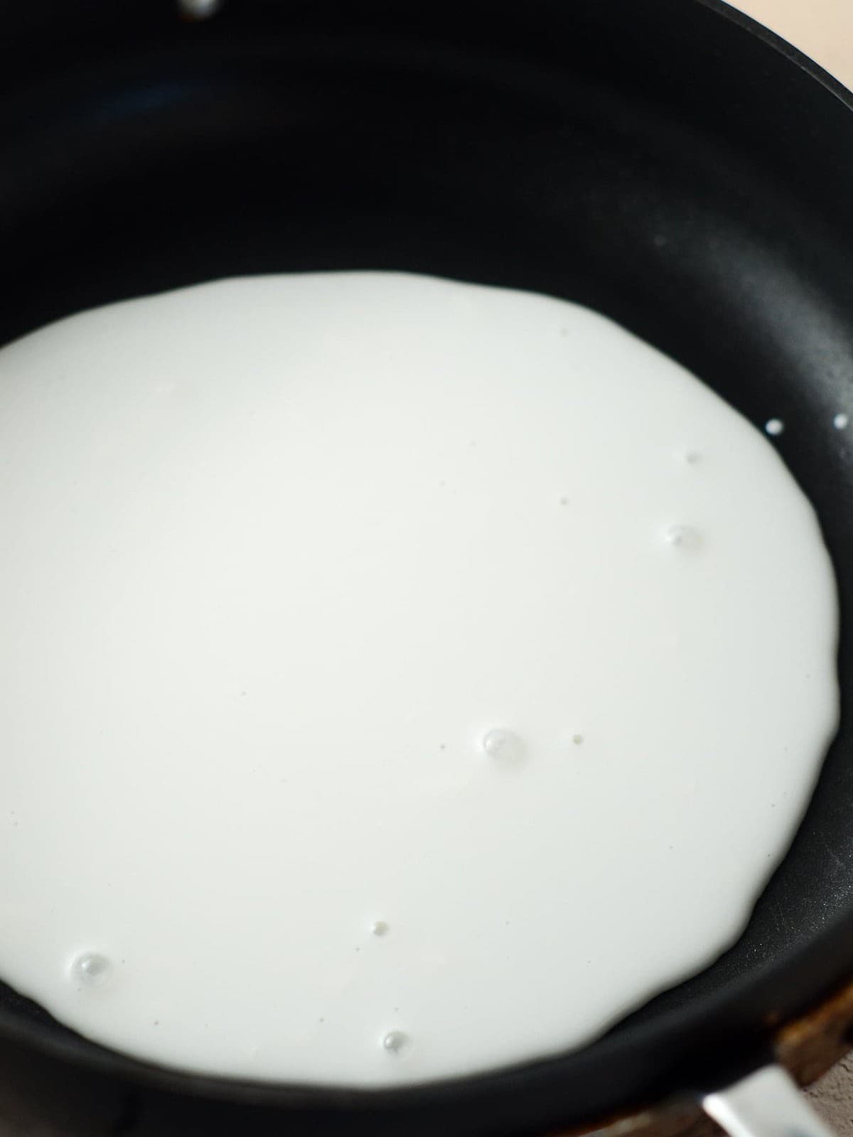 This is a photo of coconut milk on the stove.