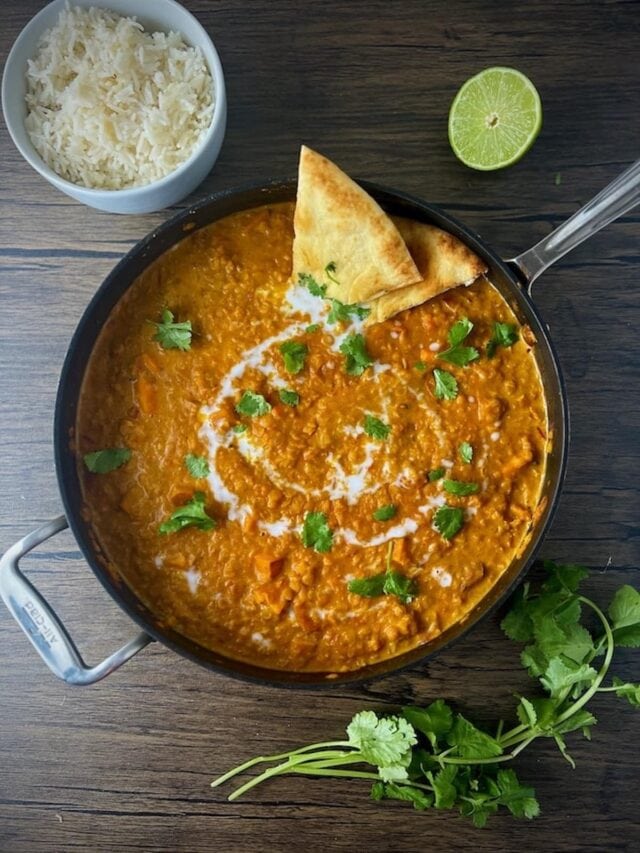 This is a photo of red lentil curry with sweet potatoes in a pan.