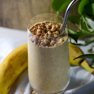 This is a photo of the gut health smoothie with granola, oats, and a banana.