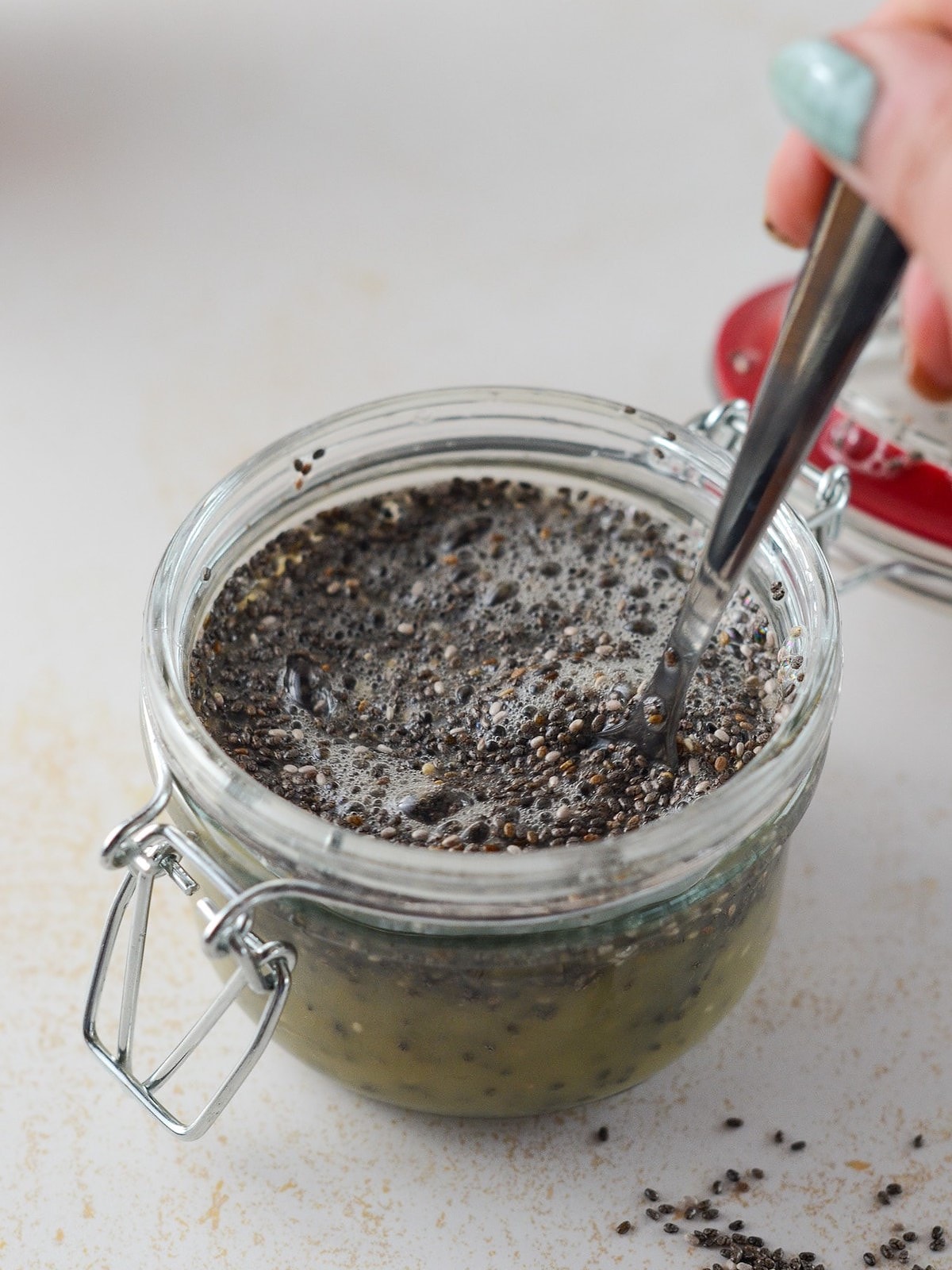 This is a photo of chia seed pudding being mixed with a spoon.