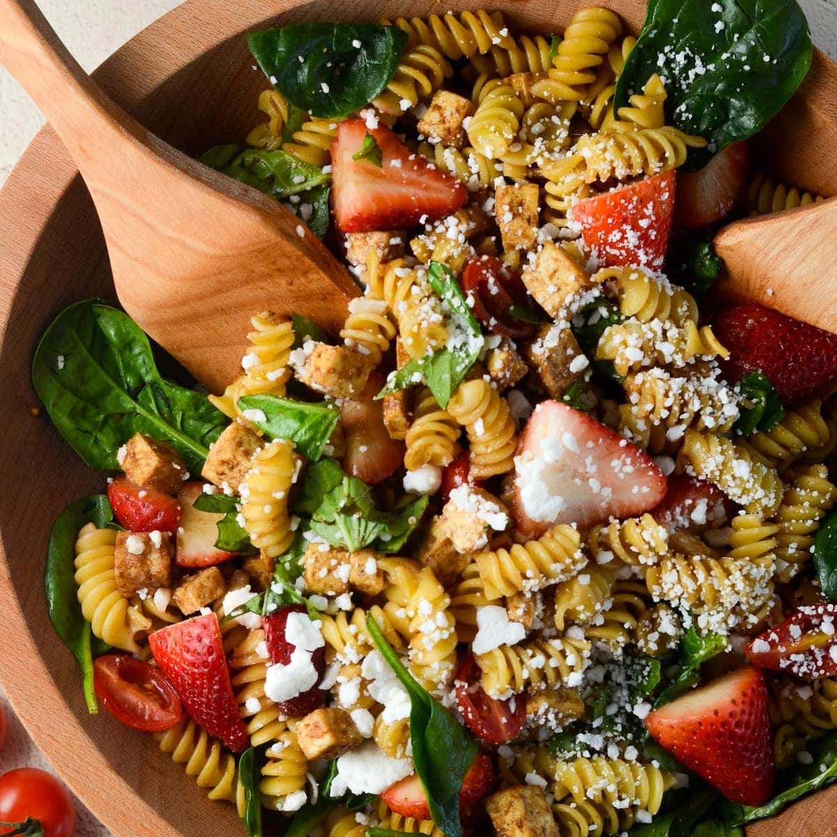 Photo of strawberry balsamic tofu pasta salad in a bowl.