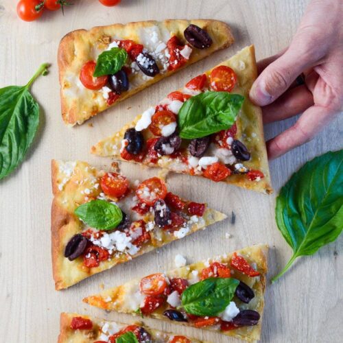 mediterranean vegan flatbread with hand