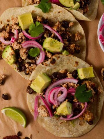 picture of tacos overhead shot. with limes and pickled onions