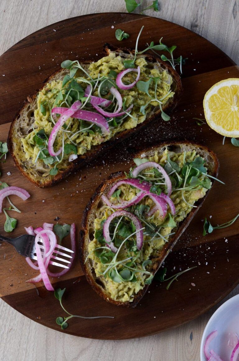 higher overhead shot of high protein avocado toast with pickeld onions on the side
