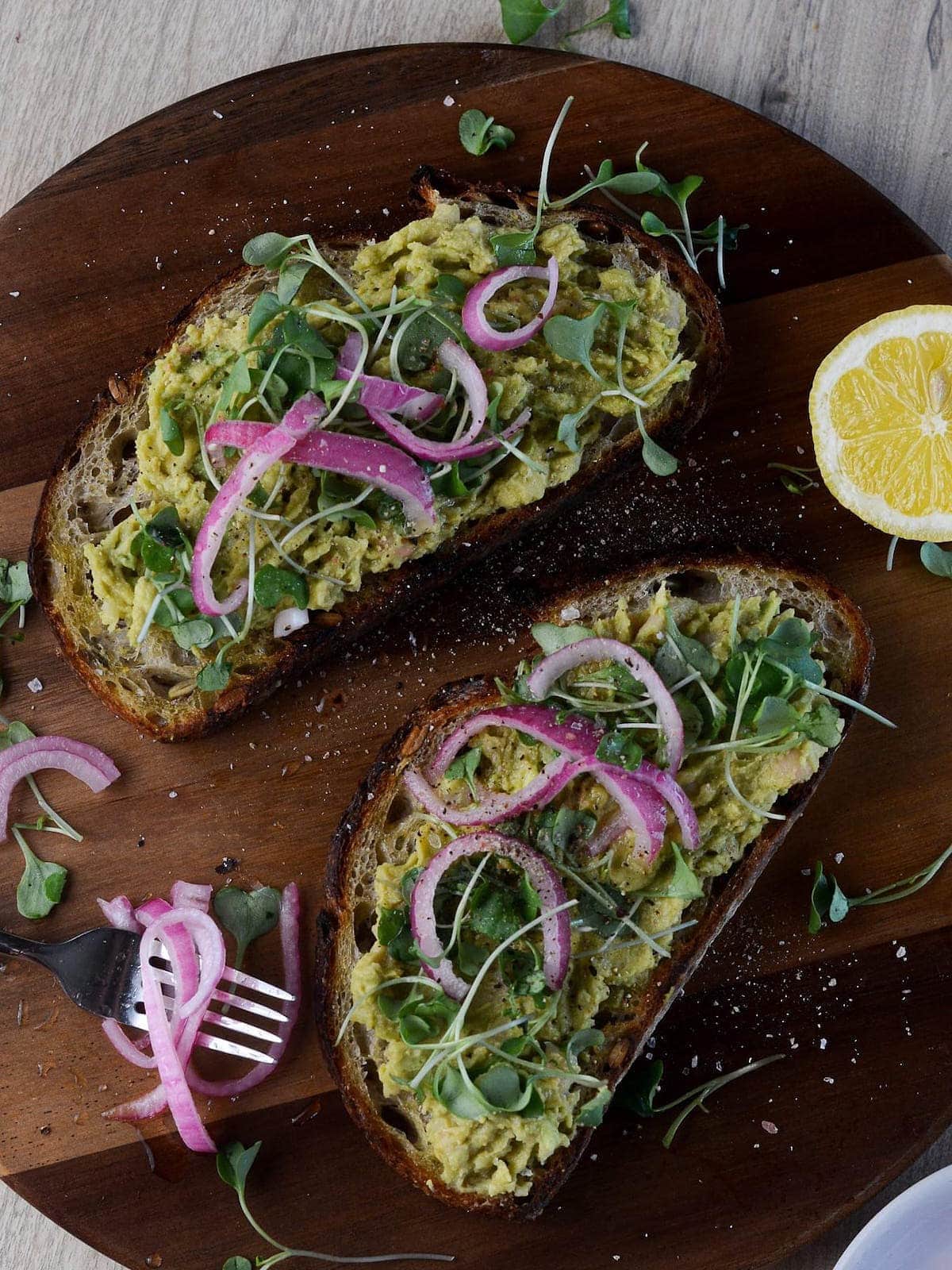 higher overhead shot of high protein avocado toast with pickeld onions on the side