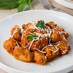 hero shot of the tofu gnocchi on a plate with parmesan and basil