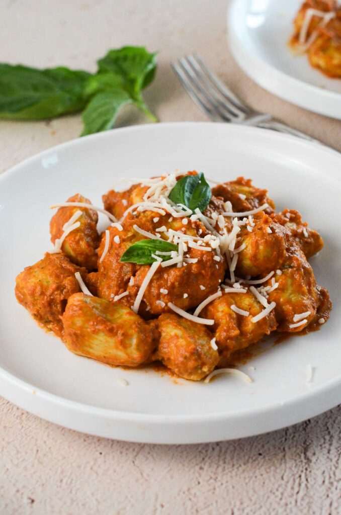 hero shot of the tofu gnocchi on a plate with parmesan and basil