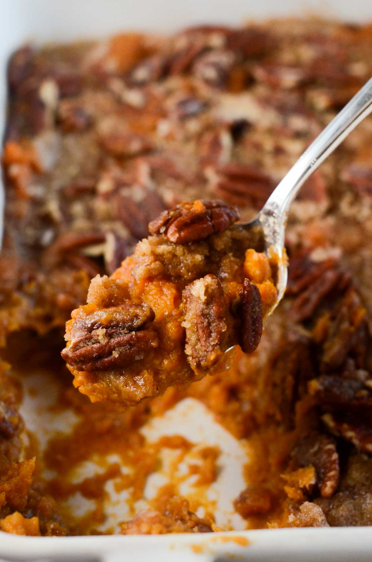 a close up picture of a spoonful of vegan sweet potato casserole.