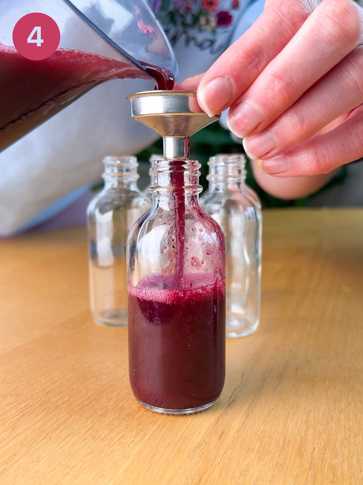 Filling vials with elderberry immunity shots.